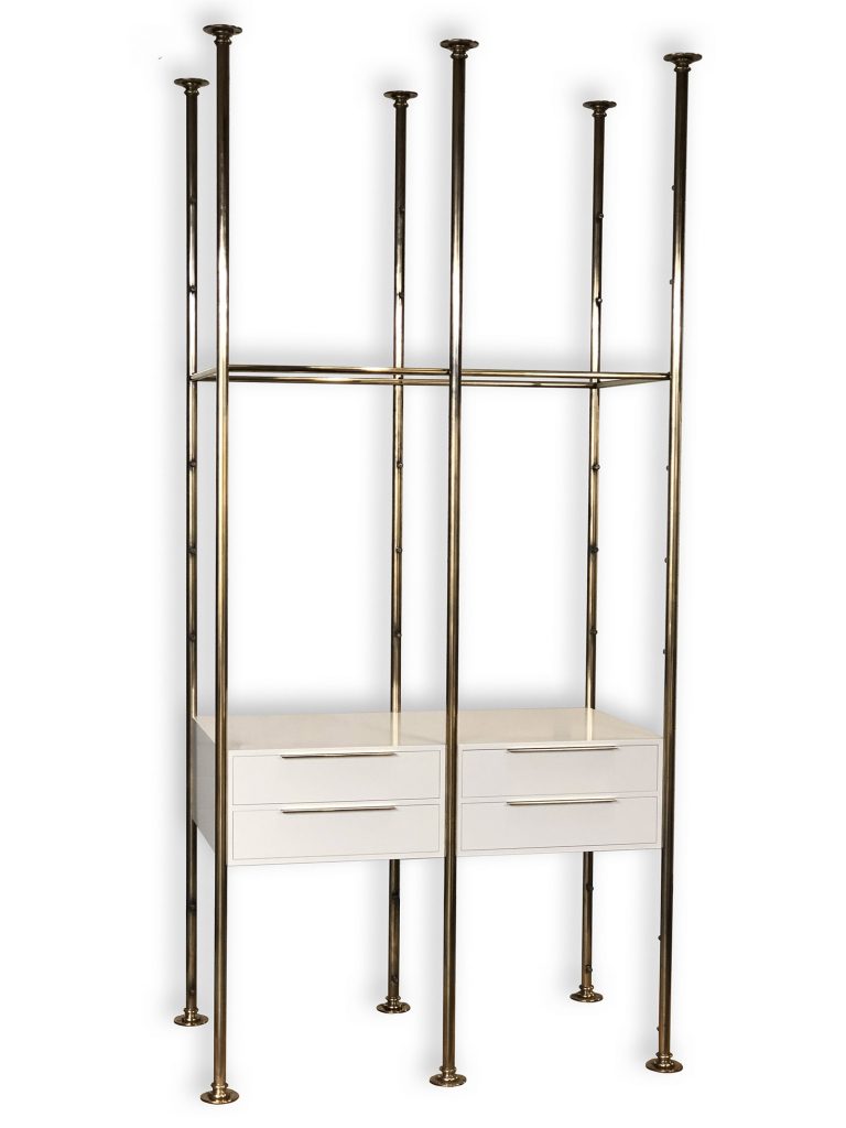 A modern, minimalist shelving unit perfectly suited for bespoke dressing room furniture, featuring four vertical metal poles and two white drawers at the base. The open top portion offers ample storage or display space, supported by sleek horizontal metal bars.