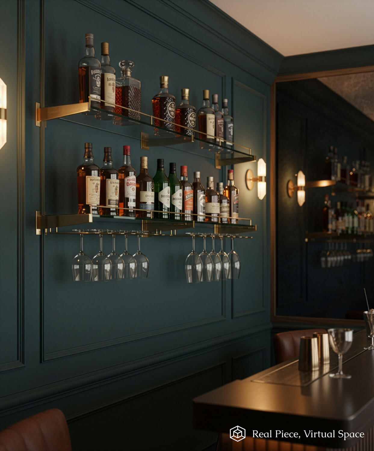 A stylish home bar with dark teal walls features brass back bar shelving, two brass-framed glass shelves displaying liquor bottles, and hanging glassware beneath. Warm wall sconces illuminate the modern, elegant space.