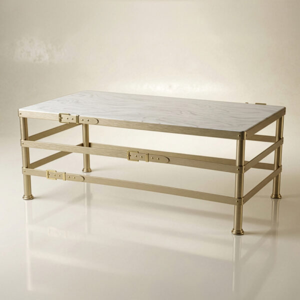 The Belted coffee table features a modern rectangular design with a white marble top, gold metal frame, and visible side hinges and screws. It stands on four short cylindrical legs and is displayed against a neutral background.